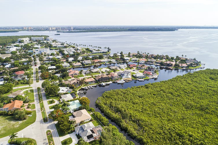 Homes line the edges of a river.