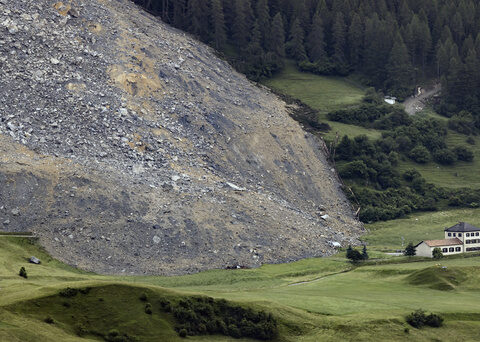 Mass of rock slides down mountainside above evacuated Swiss village, narrowly misses settlement