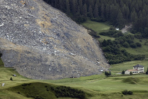 Mass of rock slides down mountainside above evacuated Swiss village, narrowly misses settlement