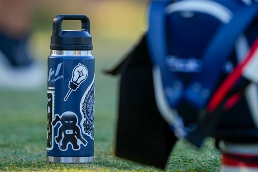 Stickers adorn Rickie Fowler's ever-present water bottle at US Open