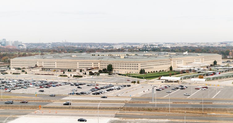 A street-level view of a five-sided office building.