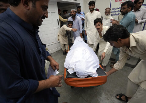 11 dead after a wall collapses near an under-construction bridge in Pakistan during monsoon rains