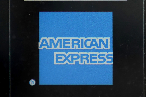 American Express profit rises, but it sets aside more money for possible defaults