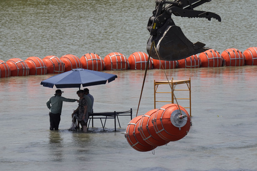 Justice Department tells Texas that floating barrier on Rio Grande raises humanitarian concerns