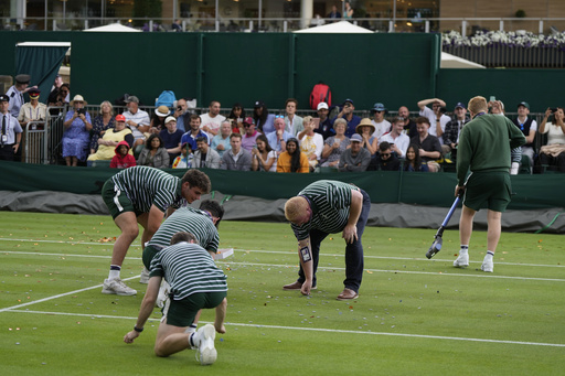 Environmental activists arrested at Wimbledon for throwing confetti and puzzle pieces on court