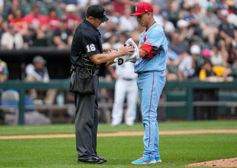 Cardinals reliever Gallegos gets wiped down by umpire after using rosin bag on his left arm