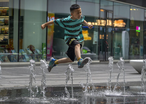 Flooding displaces 10,000 around China as Beijing gets a slight respite from an extreme heat wave