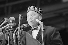 Elijah Muhammad speaks at a conference.