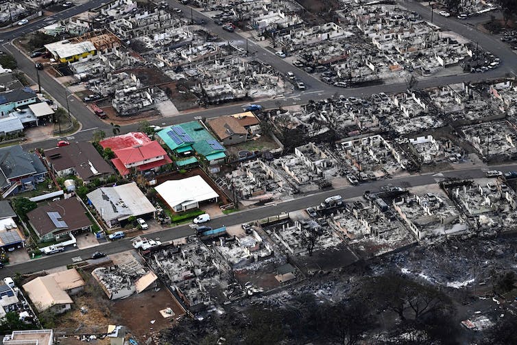 A small collection of homes appears unburned among the hulls of dozens of burned out houses.