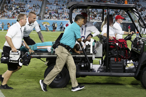 Daewood Davis of Dolphins carted off field after collision; preseason game vs. Jaguars halted