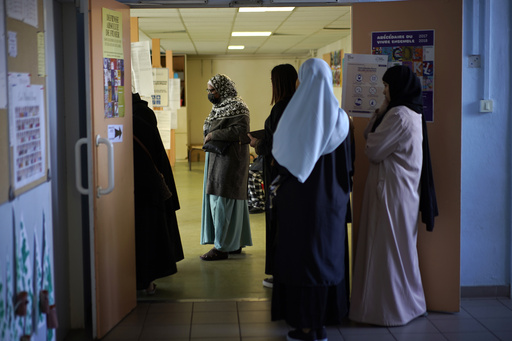 France's education minister bans long robes in classrooms worn mainly by Muslims