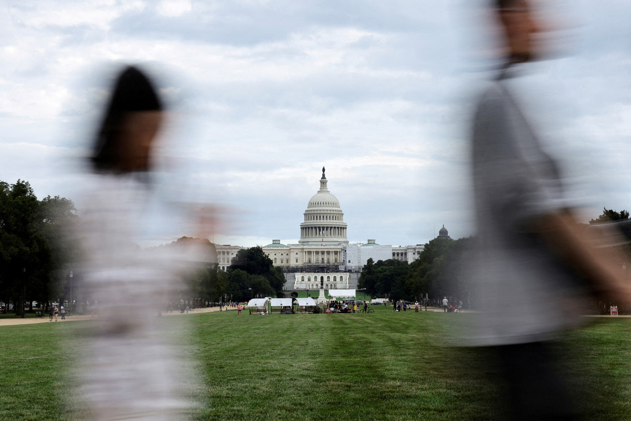 FILE PHOTO: People walk at the National Mall in front of the Capitol in Washington