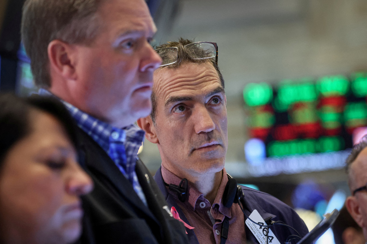 FILE PHOTO: Traders work on the floor of the NYSE in New York