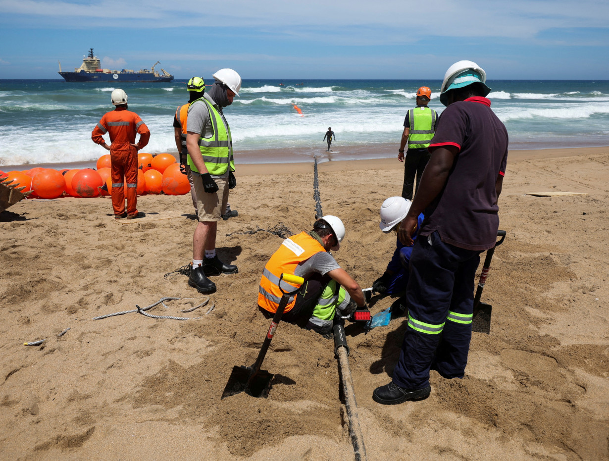 FILE PHOTO: Workers install the 2Africa undersea cable on the beach in Amanzimtoti