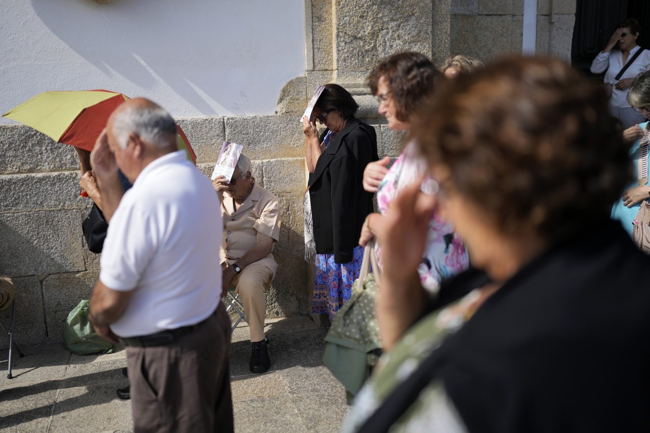 Ox-pulled floats with sacred images of Mary draw thousands to Portugal’s wine-country procession