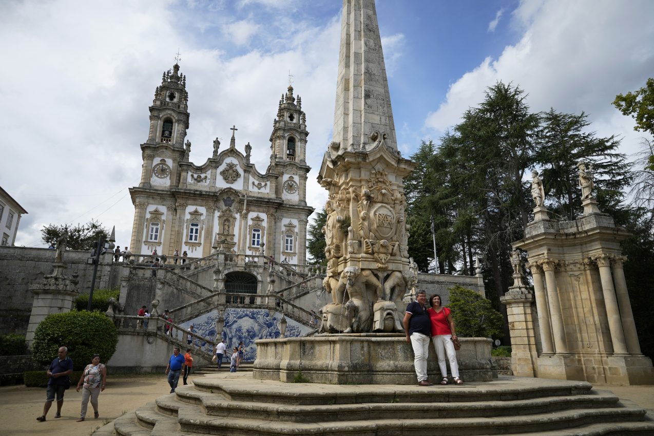 Ox-pulled floats with sacred images of Mary draw thousands to Portugal’s wine-country procession