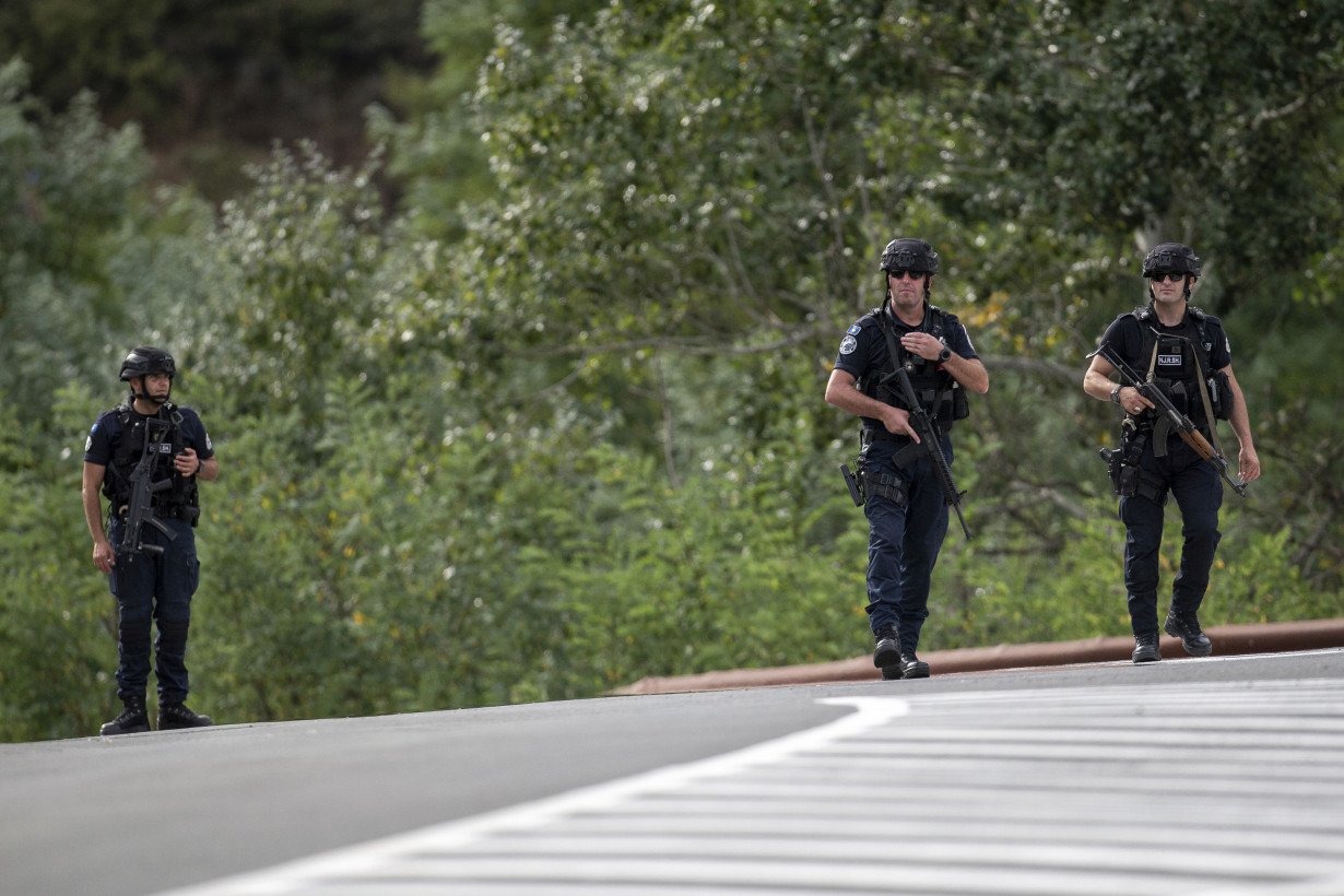 Kosovar police surround a village after Serb gunmen storm a monastery in violence that has killed 4