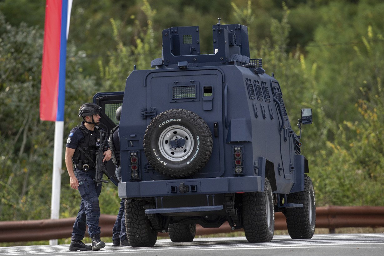 Kosovar police surround a village after Serb gunmen storm a monastery in violence that has killed 4