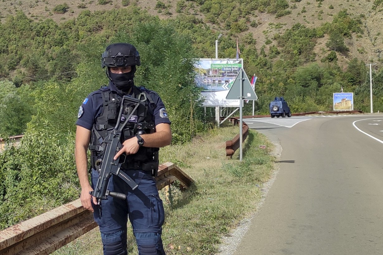 Kosovar police surround a village after Serb gunmen storm a monastery in violence that has killed 4