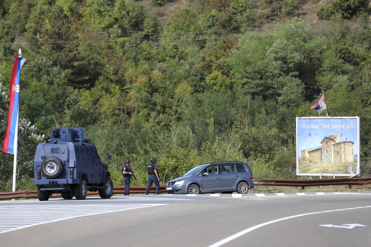 Kosovar police surround a village after Serb gunmen storm a monastery in violence that has killed 4