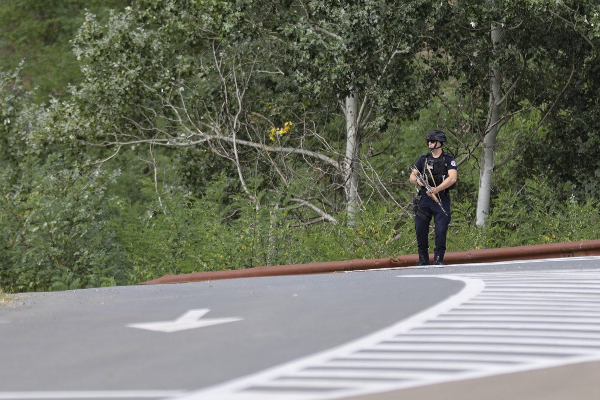 Kosovar police surround a village after Serb gunmen storm a monastery in violence that has killed 4