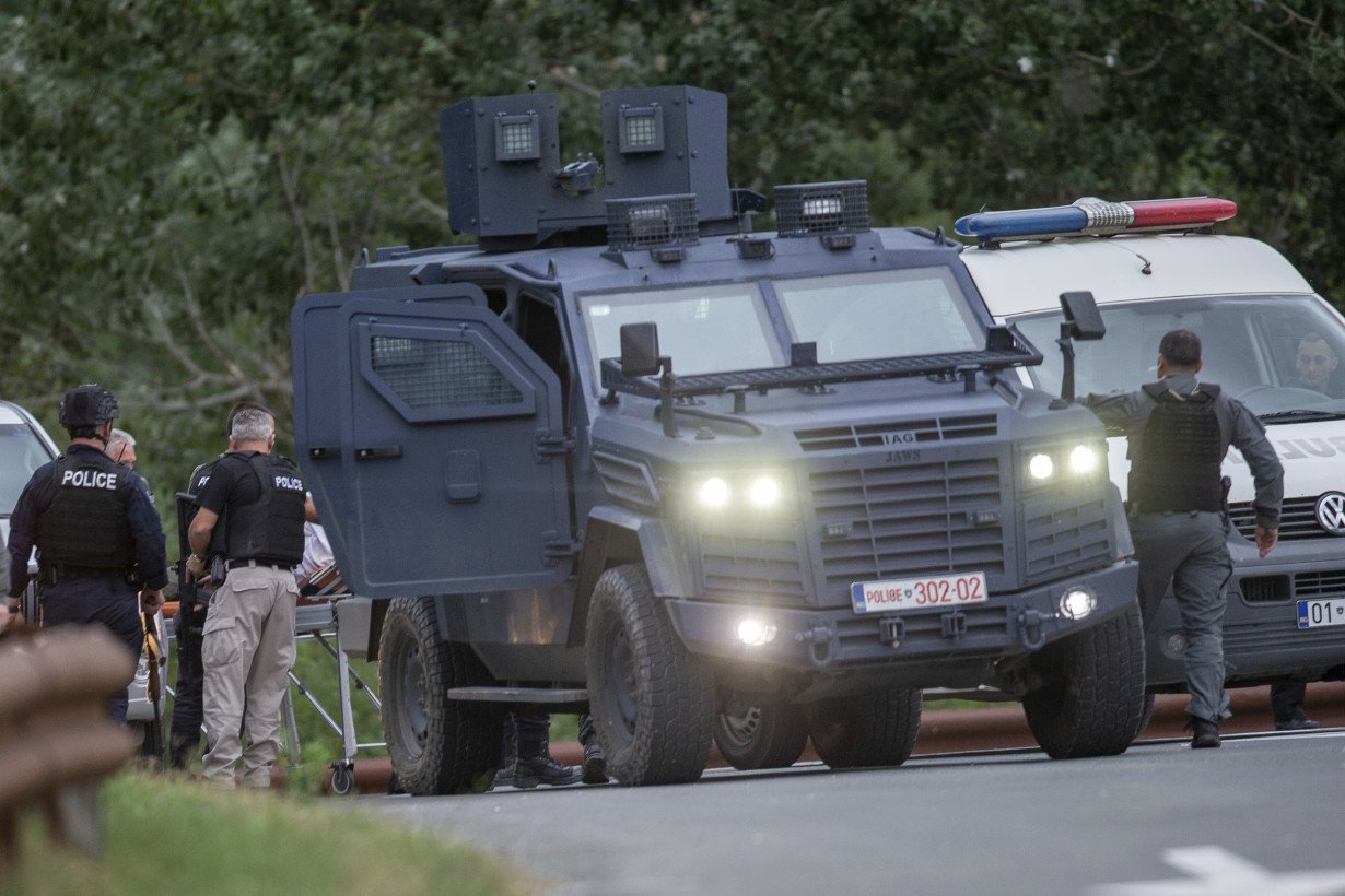 Kosovar police surround a village after Serb gunmen storm a monastery in violence that has killed 4