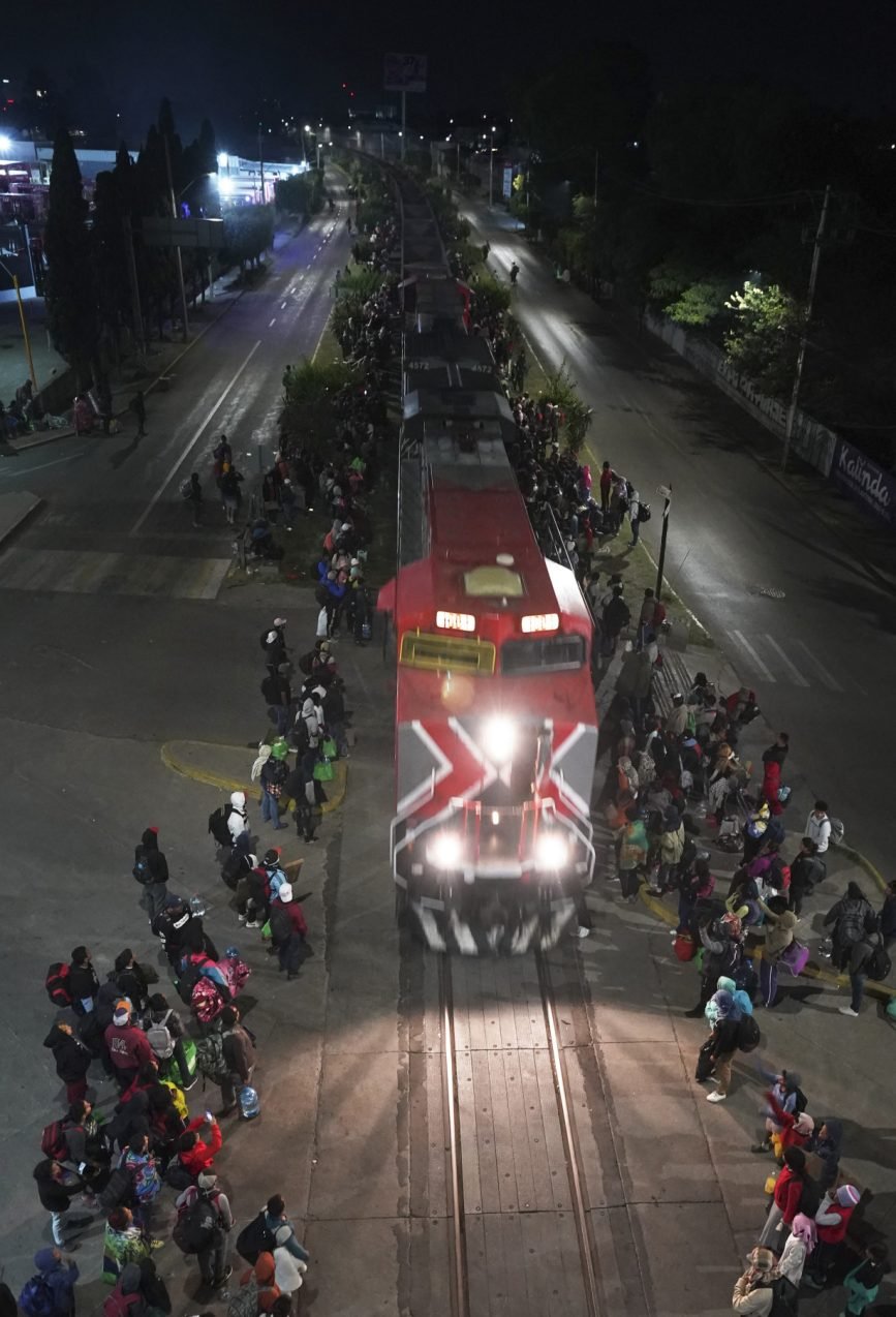 Migrants hoping to reach US continue north through Mexico by train amid historic migration levels