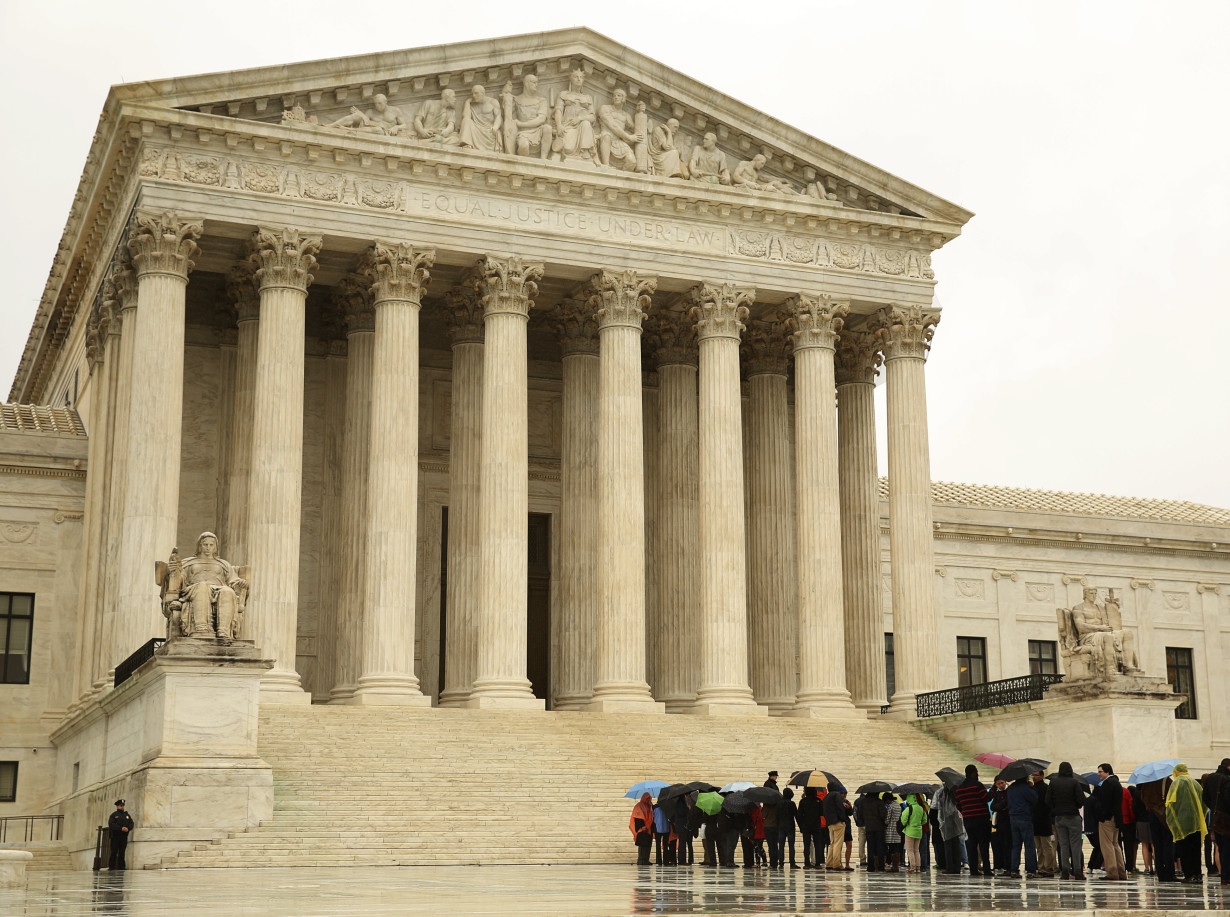 People line up in the rain outside of the US Supreme Court in Washington