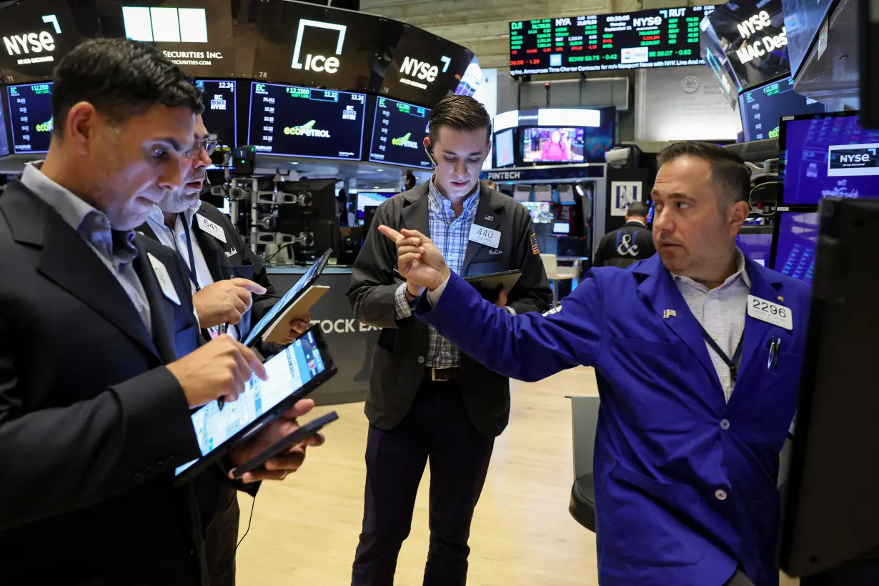 Traders work on the floor of the NYSE in New York