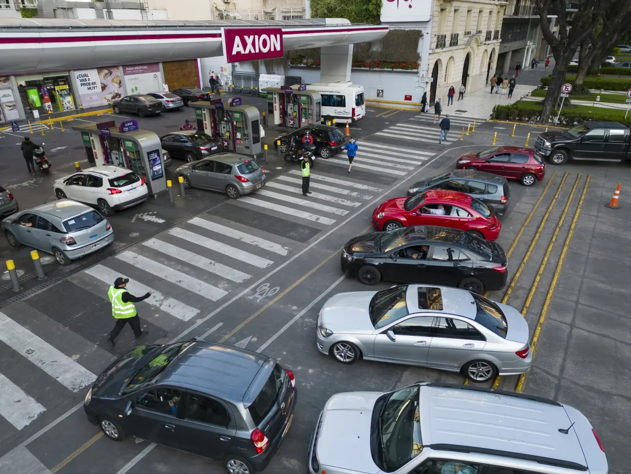 Drivers in Argentina wait in long lines to fill up the tanks as presidential election looms