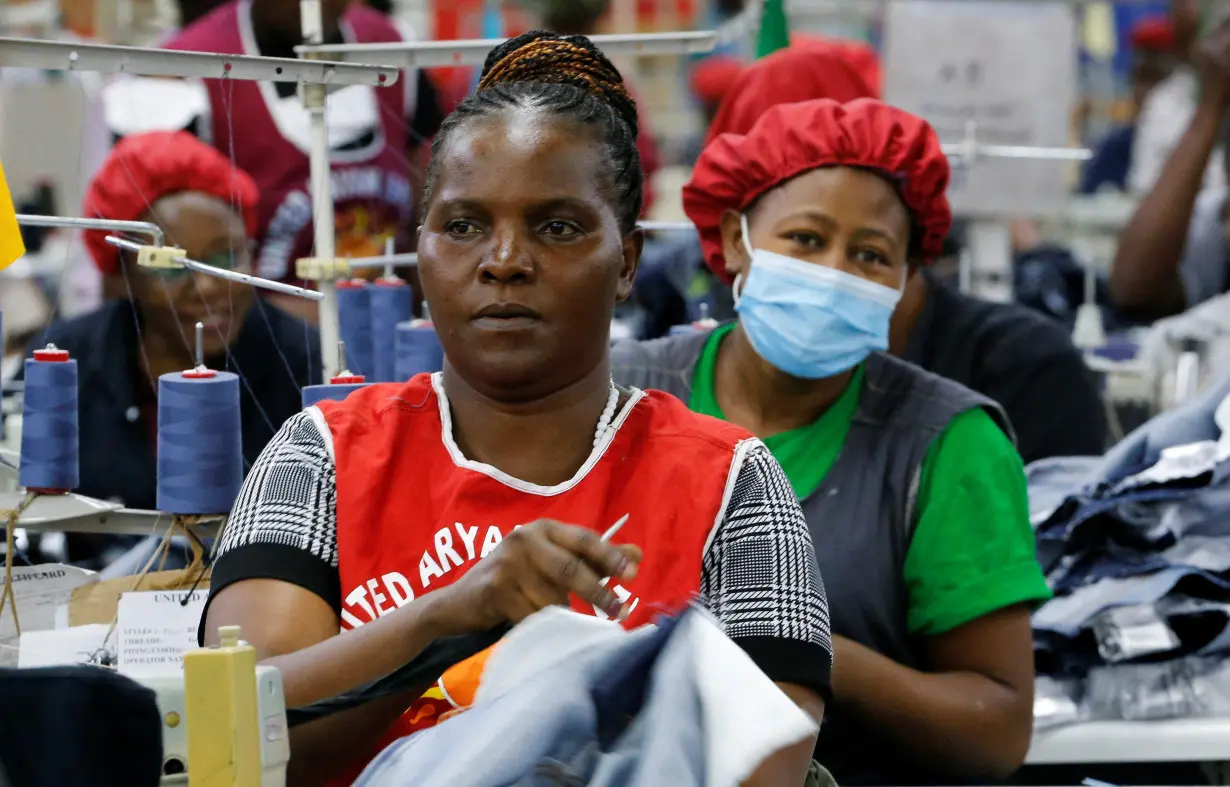 Norah Nasimiyu works on denim trousers for export at the United Aryan EPZ factory in Ruaraka district of Nairobi