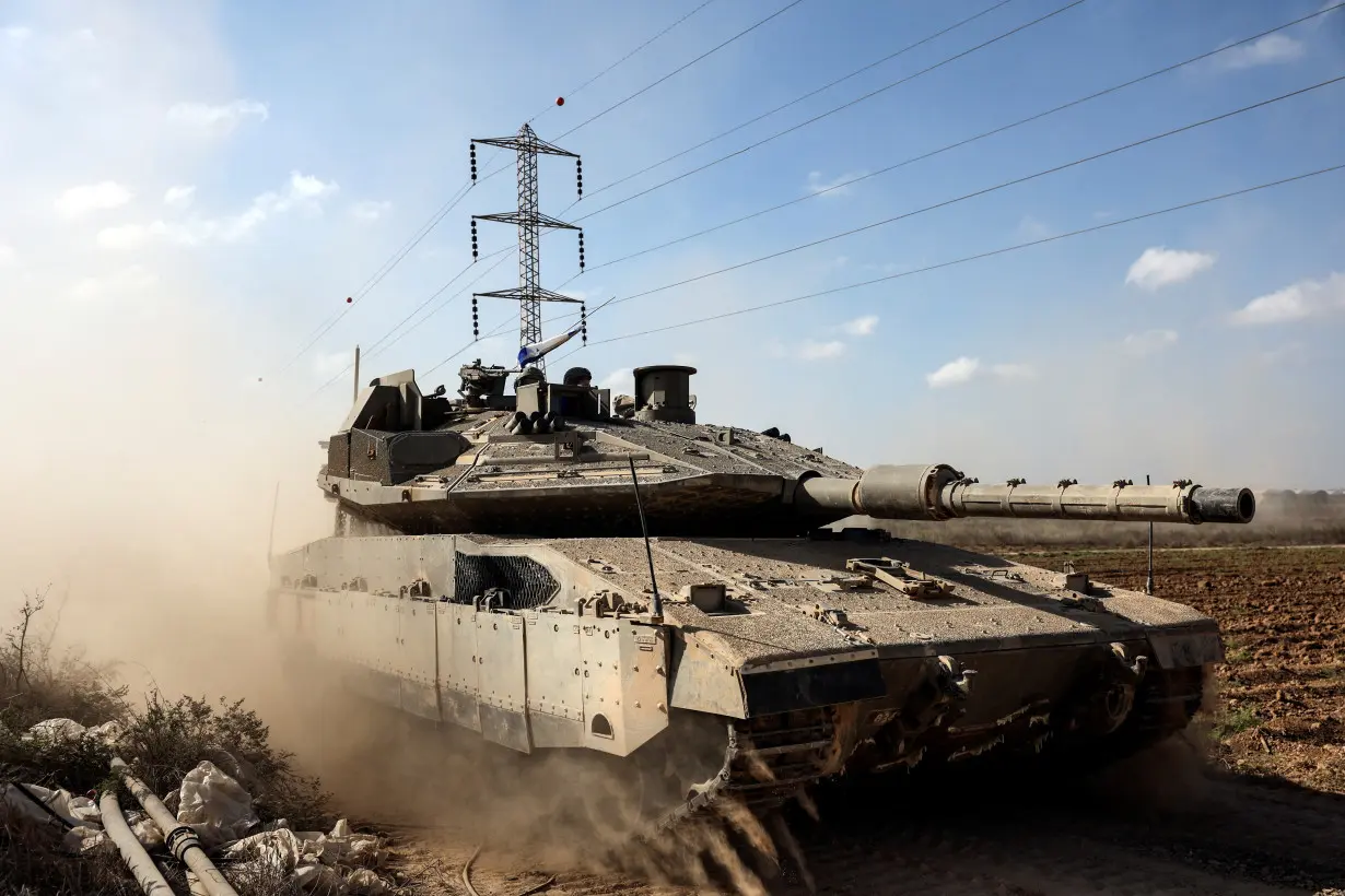 Israeli tanks take up position near Israel's border with the Gaza Strip, in southern Israel