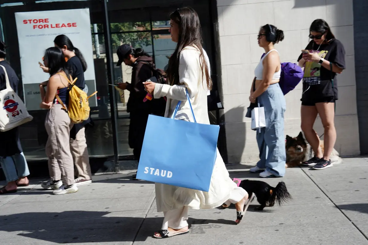 FILE PHOTO: Shoppers in New York’s SoHo