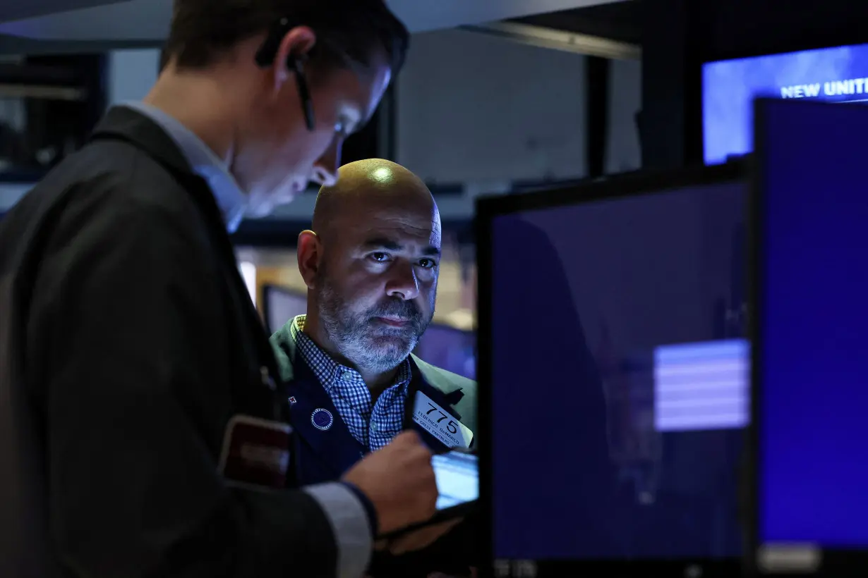 Traders work on the floor of the NYSE in New York