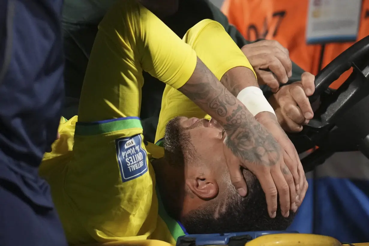 Neymar leaves Brazil match in tears with left knee injury; team doctor says severity unknown