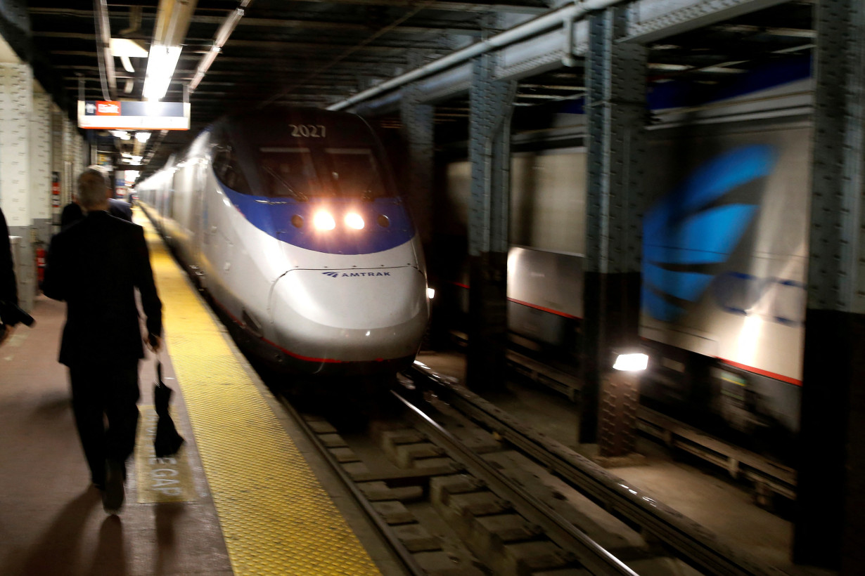 FILE PHOTO: An Amtrak Acela train arrives at New York's Penn Station, the nation's busiest train hub, near a section of a complex of tracks that Amtrak says they will begin repairing over the summer in New York City