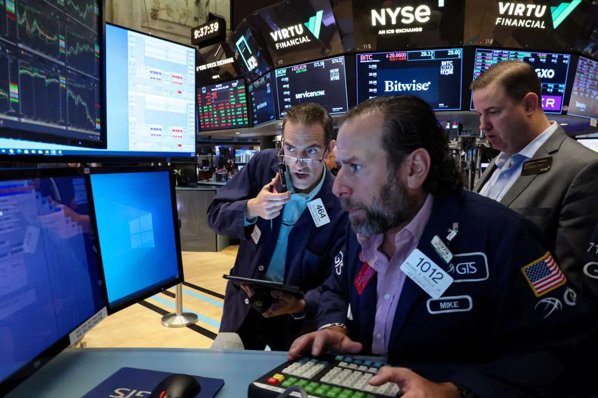 Traders work on the floor of the NYSE in New York