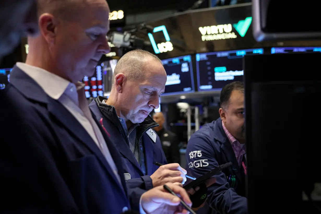 Traders work on the floor of the NYSE in New York