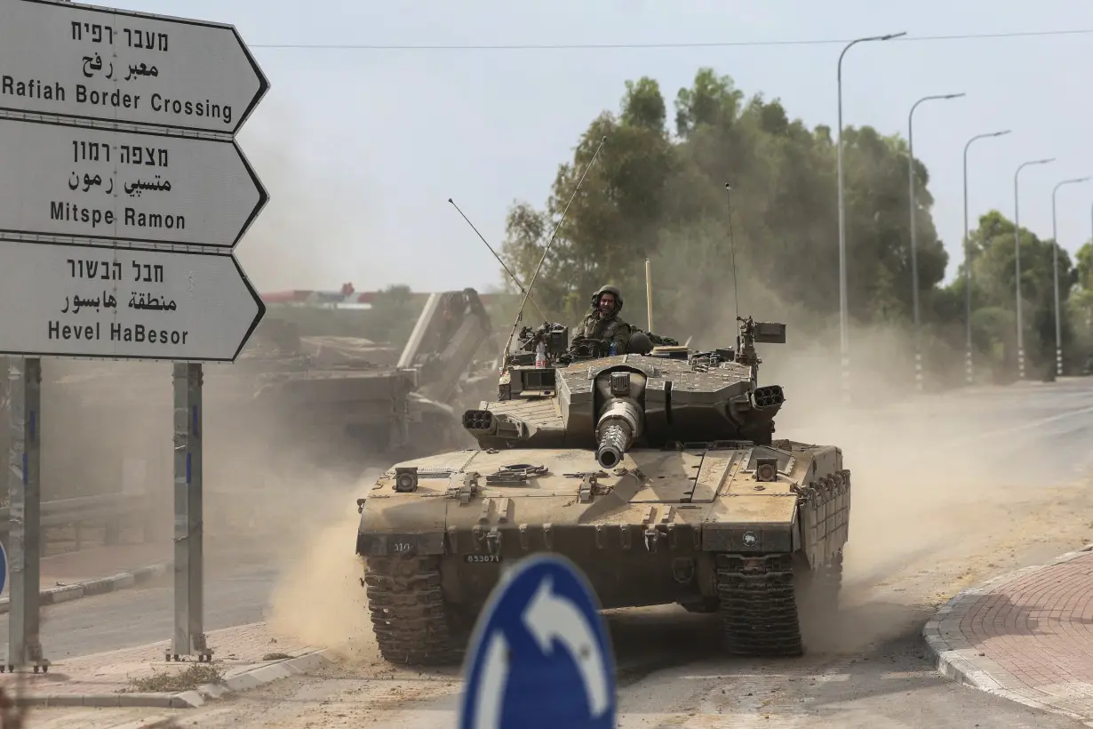 FILE PHOTO: Israeli soldiers drive in a tank by Israel's border with Gaza in southern Israel