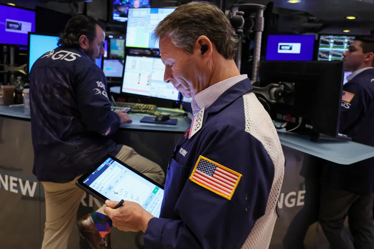 Traders work on the floor of the NYSE in New York