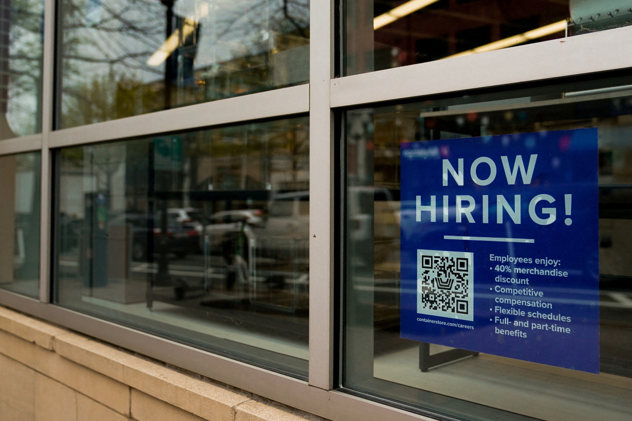 FILE PHOTO: An employee hiring sign with a QR code is seen in a window of a business in Arlington