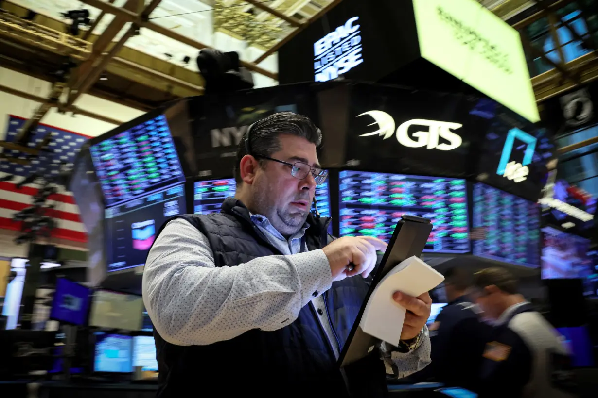 Traders work on the floor of the NYSE in New York