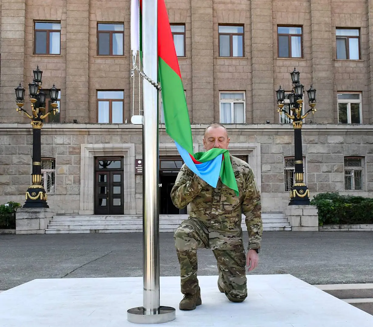 Azerbaijan's president raises the nation's flag in a former breakaway region's capital