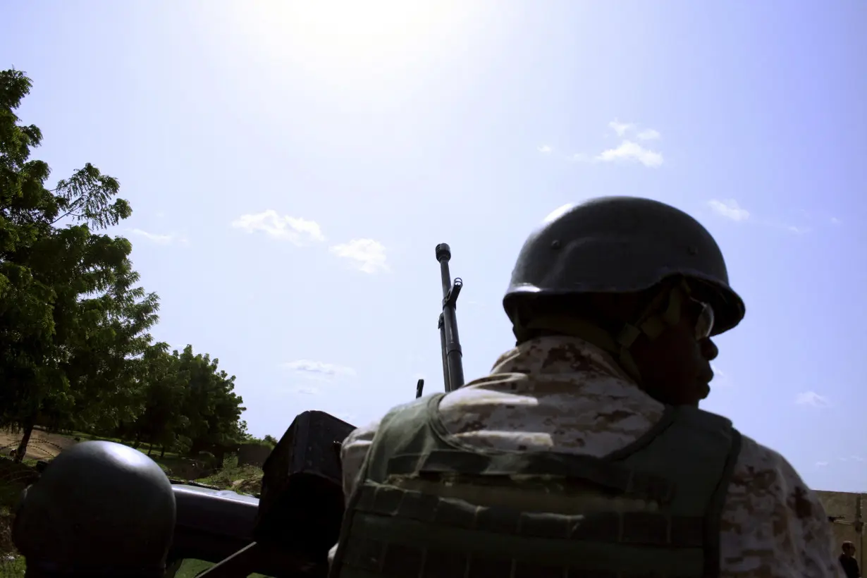 FILE PHOTO: A soldier from Niger escorts U.S. soldiers back to their base