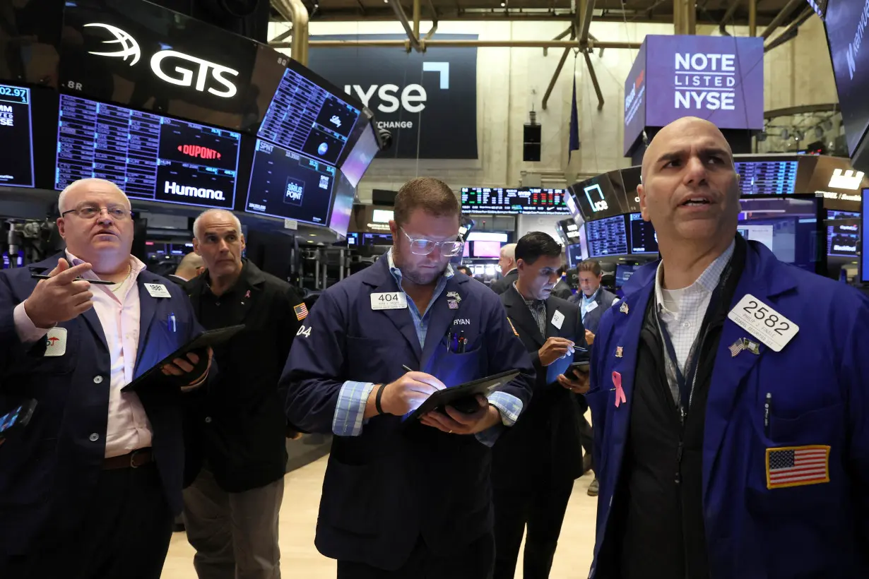 Traders work on the floor of the NYSE in New York