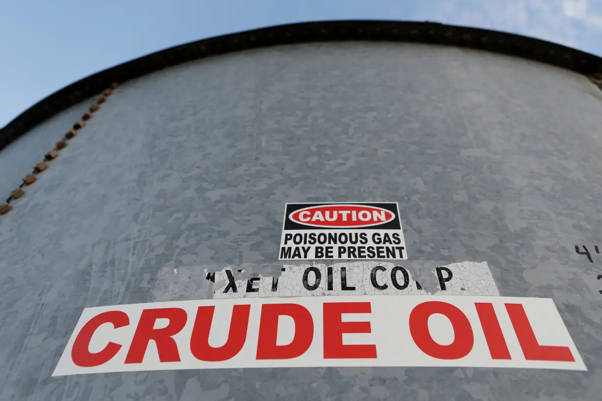 A sticker reads crude oil on the side of a storage tank in the Permian Basin