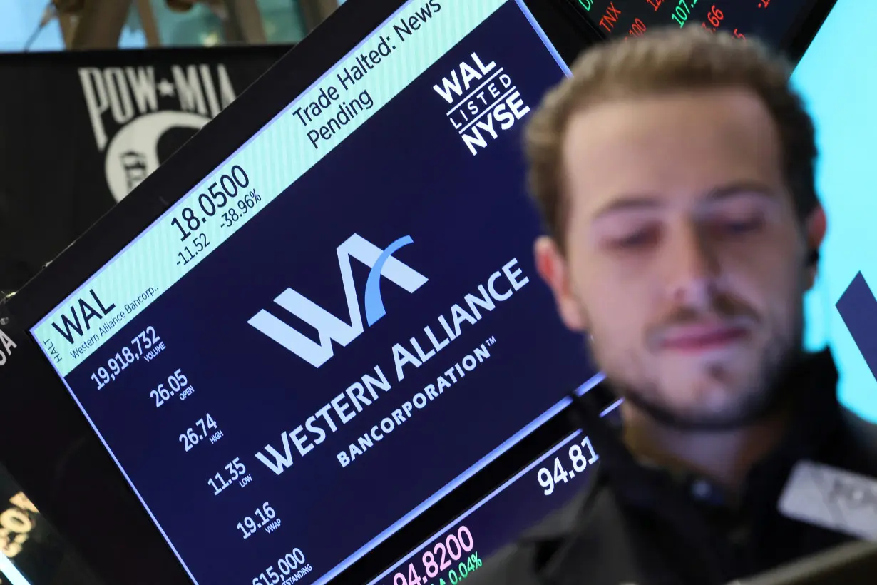 FILE PHOTO: Traders work on the floor of the NYSE in New York