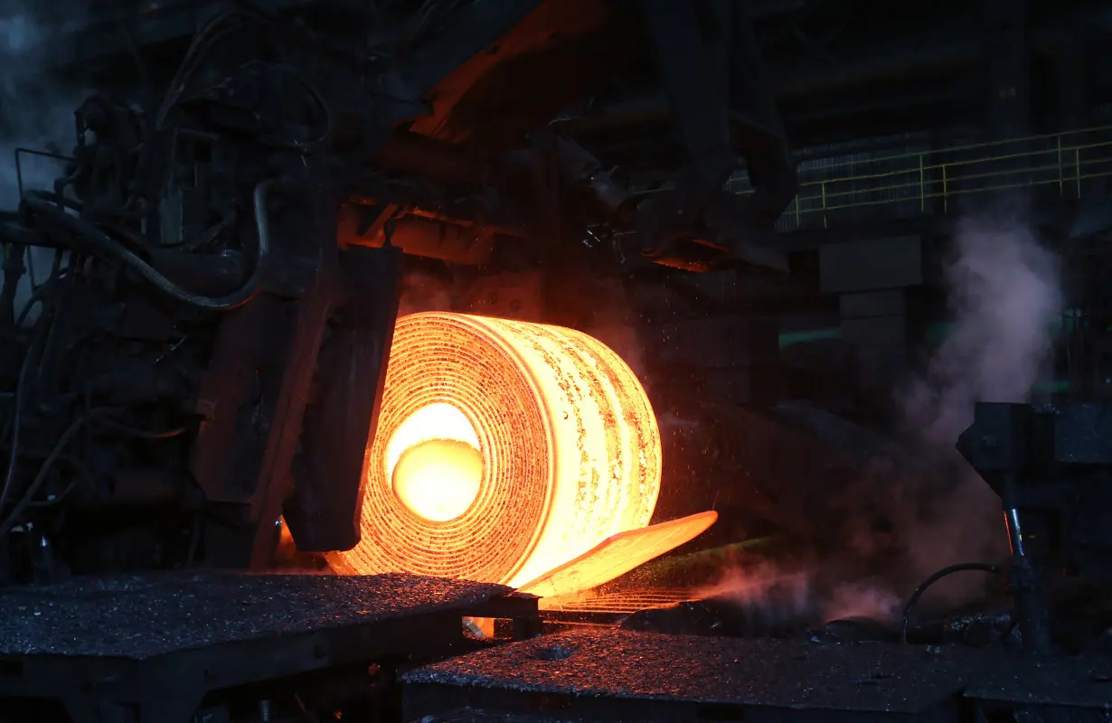 A steel coil is unrolled on the line at the Novolipetsk Steel PAO steel mill in Farrell, Pennsylvania