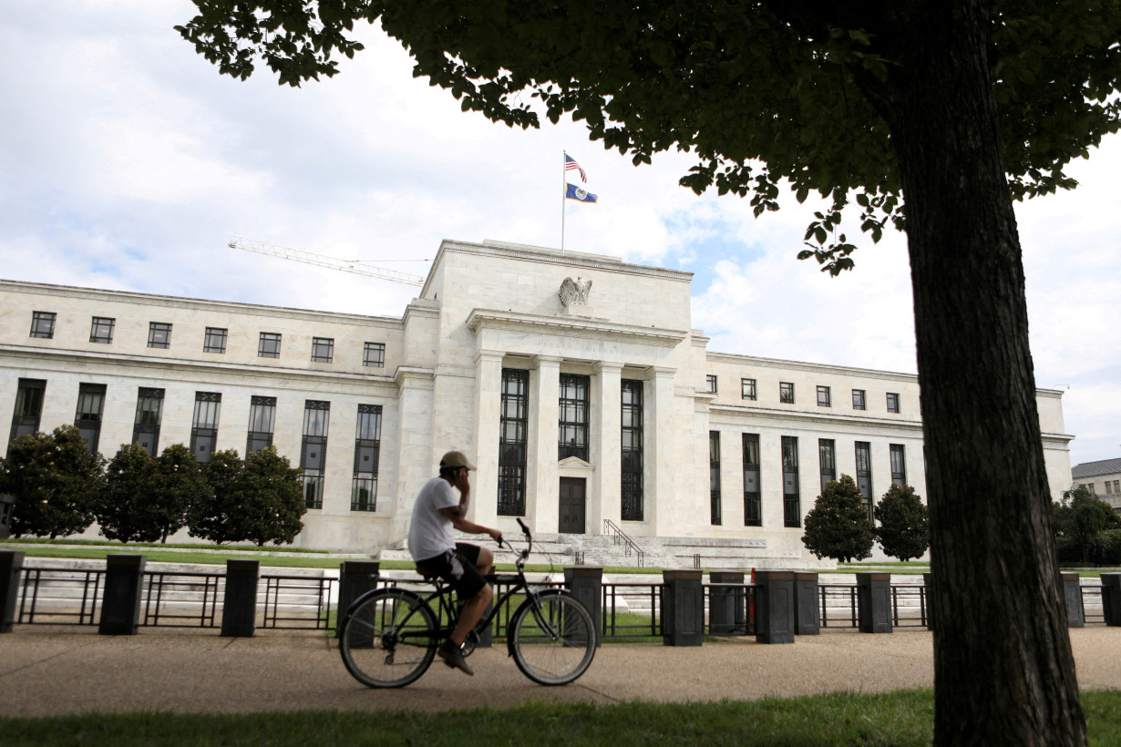 FILE PHOTO: FILE PHOTO: A cyclist passes the Federal Reserve building in Washington, DC