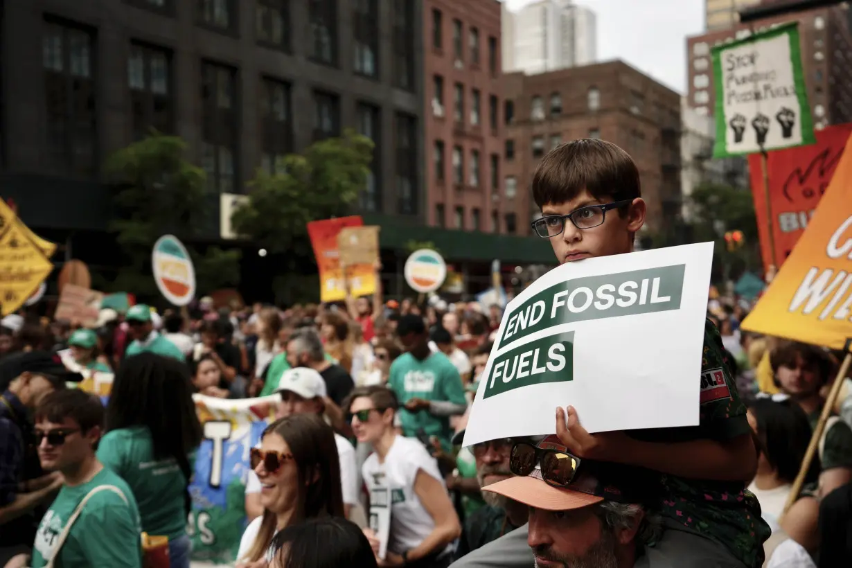 Tens of thousands march to kick off climate summit, demanding end to warming-causing fossil fuels